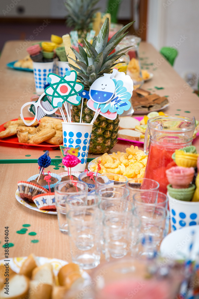Children's party, lots of sweets, candy, cookies and fruit, colorful table