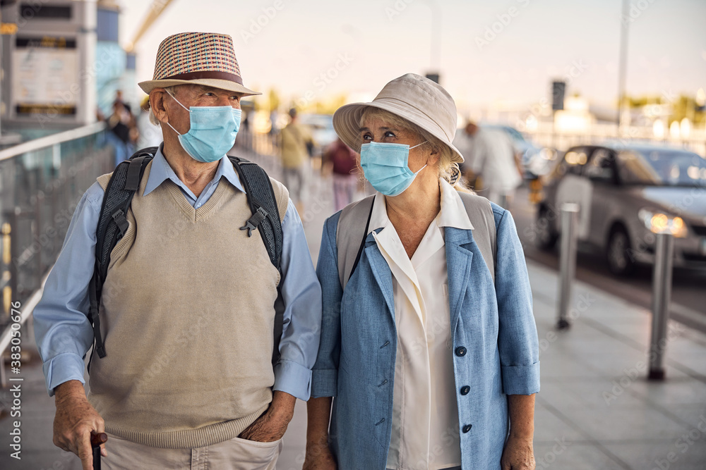 Aged woman staring at her husband with a walking cane Aged woman staring at her husband with a walking cane