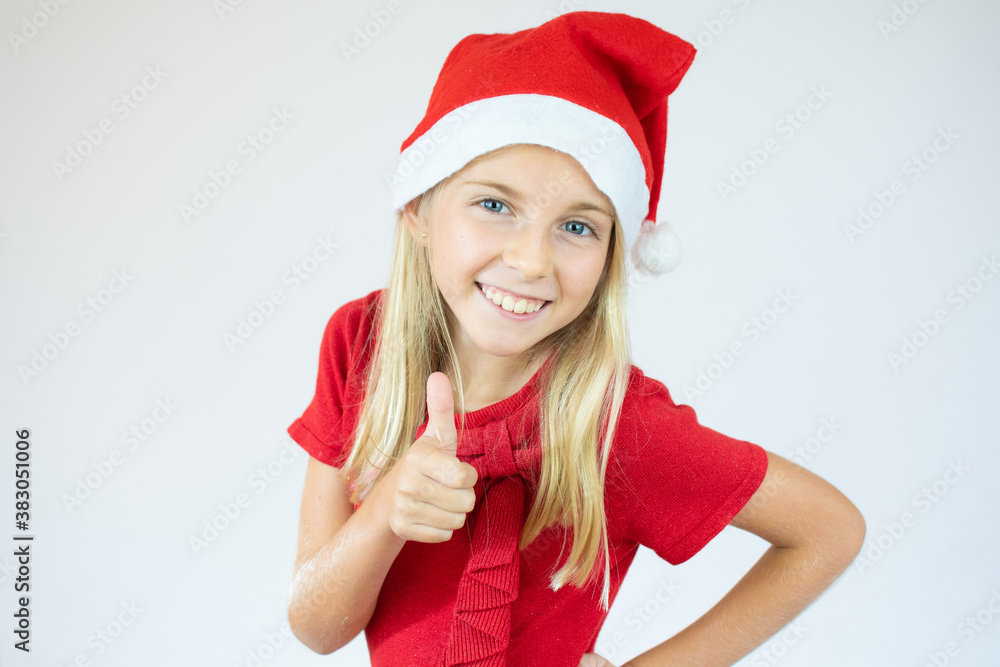 Close up portrait of a little girl in a red dress and red Christmas Santa hat Close up portrait of a little girl in a red dress and red Christmas Santa hat