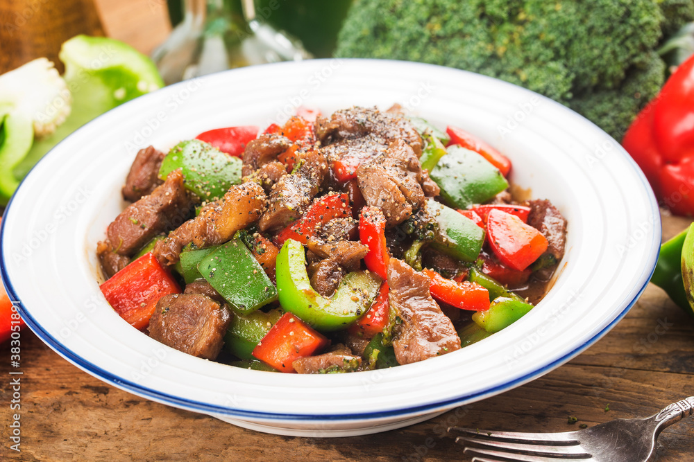 A plate of fried beef cubes with green pepper A plate of fried beef cubes with green pepper