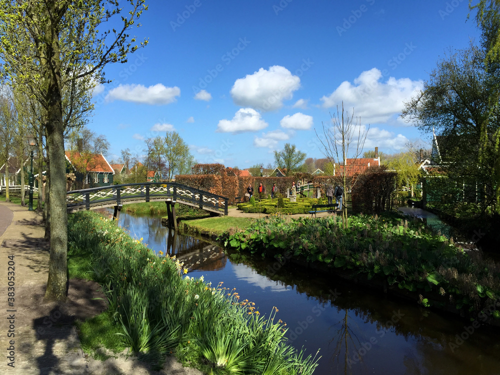 landscape with village and river against blue sky in Zaanse Schans, North Holland, Netherlands landscape with village and river against blue sky in Zaanse Schans, North Holland, Netherlands