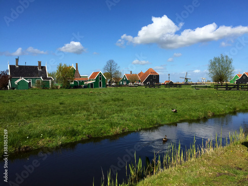 landscape with village and river against blue sky in Zaanse Schans, North Holland, Netherlands