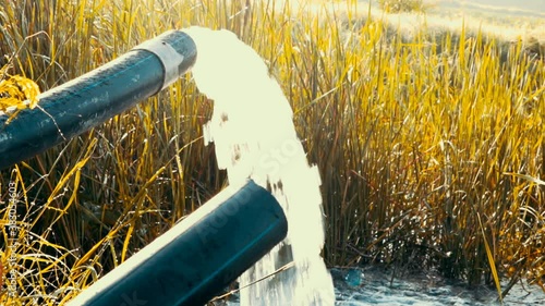 farmers are pumping water into the fields, pump pipe water flow equipment agriculture,Pumping water out of plastic pipe into the ground, 
