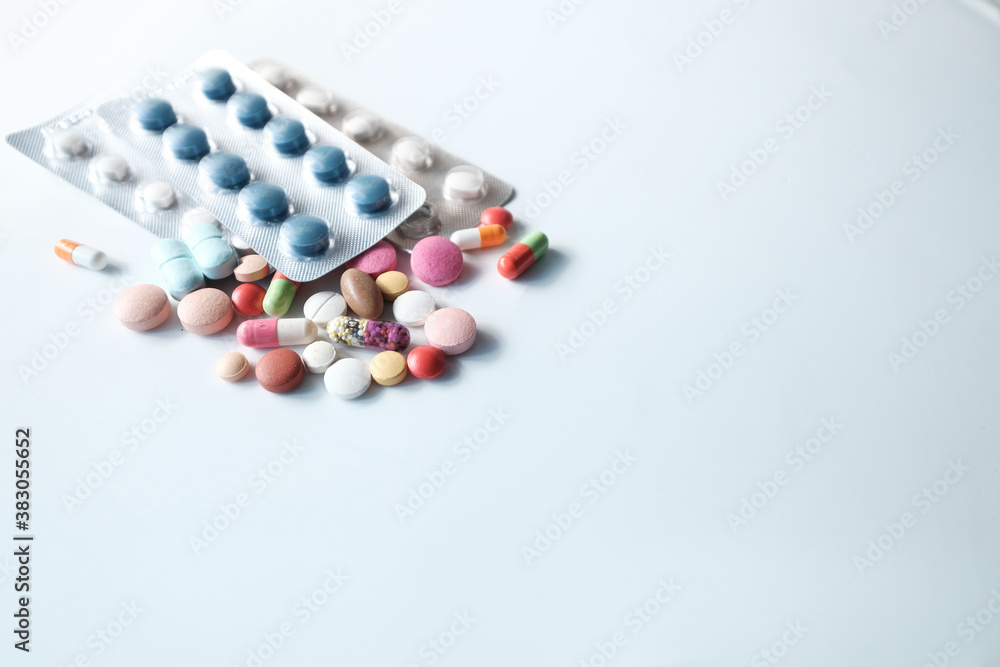 close up of colorful pills spilling on white background close up of colorful pills spilling on white background