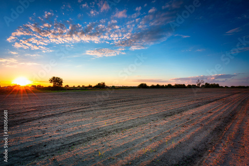 Beautiful landscape of a plowed field at sunset. Poland