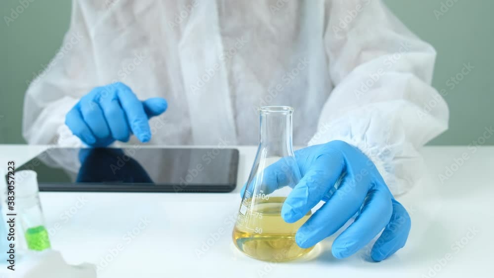 Man scientist is analyzing with a pipette a liquid golden yellow to extract the DNA and molecules in the test tubes in laboratory. Man scientist is analyzing with a pipette a liquid golden yellow to extract the DNA and molecules in the test tubes in laboratory.