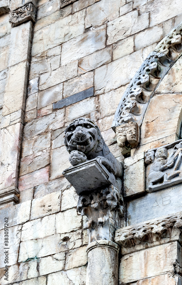 Lion statue on the main portal of the Collegiate Church of San Cristoforo, or Duomo di Barga, built in the 11the century in Romanesque style.