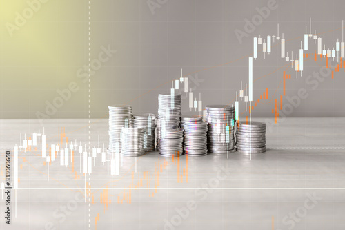 concept silver coin stack business money, light and graph background 