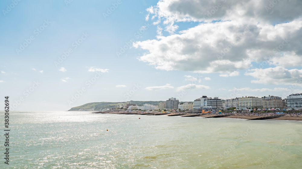 Eastbourne beach and seafront, England. A busy summer seafront at the popular English seaside resort on the Sussex coast.