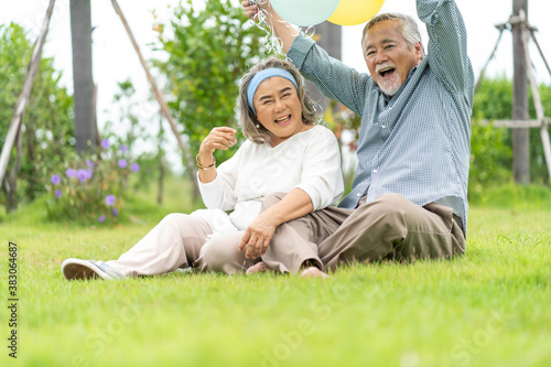 Wallpaper Mural Asian senior Couple playing and tease each other with balloon in the garden. Happy elderly people at home. Happy family concept. Torontodigital.ca