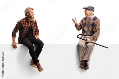 Elderly man talking to a bearded guy and sitting on a white panel