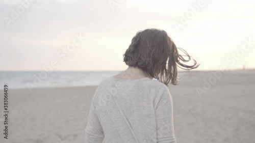 Beautiful happy Woman walking on the beach towards sunset, 1080p 50fps slog 2 photo