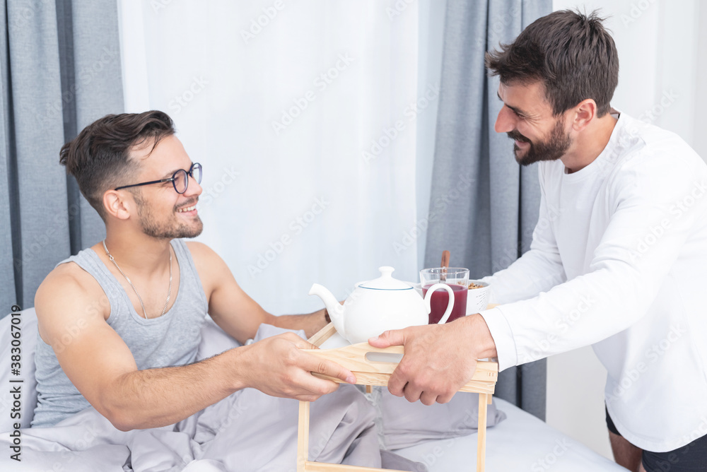 Gay man serving meal to boyfriend Gay man serving meal to boyfriend
