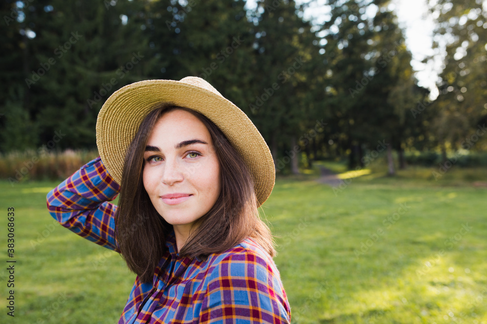 portrait of a beautiful woman in a straw hat