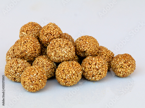 White sesame seed balls made with heated  jiggery against white background