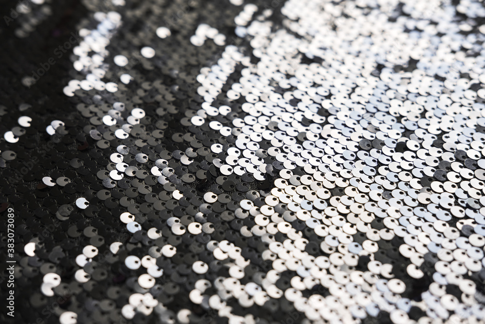 Sequin fabric texture. Shiny silver sparkling background. Clothing