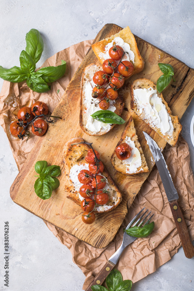 Tasty tapas, snack or crostini or Bruschetta with toasted baguette, roasted tomatoes. Delicious breakfast, snack, appetizers Tasty tapas, snack or crostini or Bruschetta with toasted baguette, roasted tomatoes. Delicious breakfast, snack, appetizers