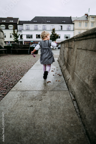Little girl running in city