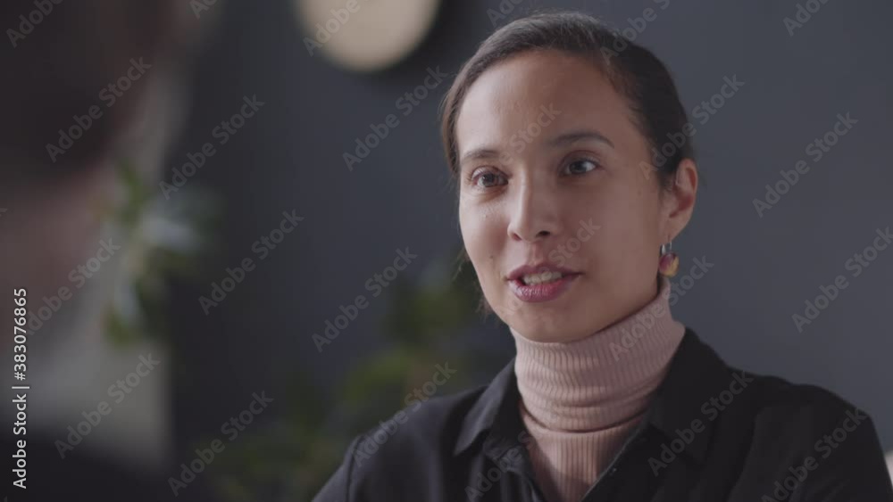 Selective focus shot of young beautiful woman of mixed-race ethnicity having discussion with HR manager during job interview in the office Selective focus shot of young beautiful woman of mixed-race ethnicity having discussion with HR manager during job interview in the office