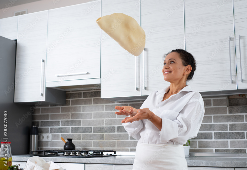 Cook forms a pizza blank from the dough, tossing up. Cook forms a pizza blank from the dough, tossing up.