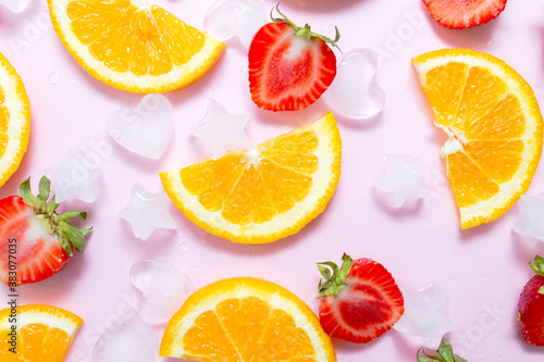 fruit salad concept. sweet strawberries and orange on bright pink paper background. Summer heat. vitamin drink  health and immunity care. detox tea or lemonade. Flatlay  copy spase