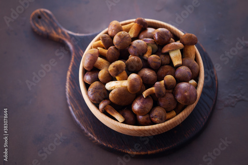 wooden bowl full of fresh mushrooms