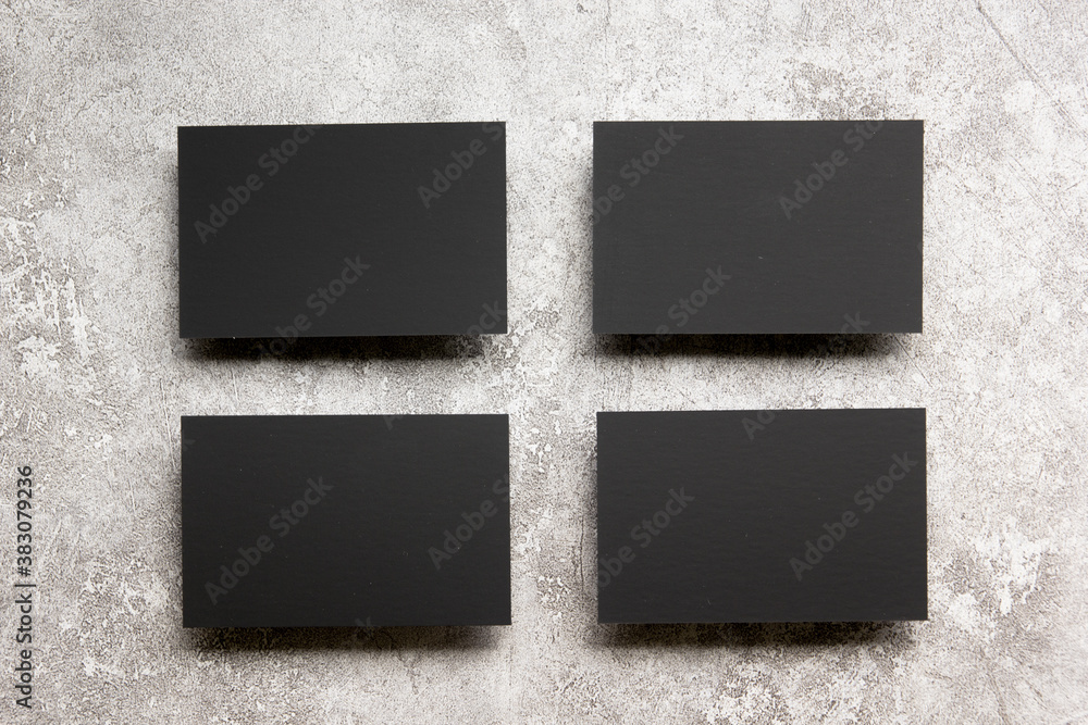 Fototapeta premium Black business cards blank on textured background. Identity design, corporate templates, company style. Flat lay