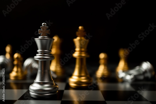 Silver King chess standing in front of other chess, Concept of a leader must have courage and challenge in the competition, leadership and business vision for a win in business games