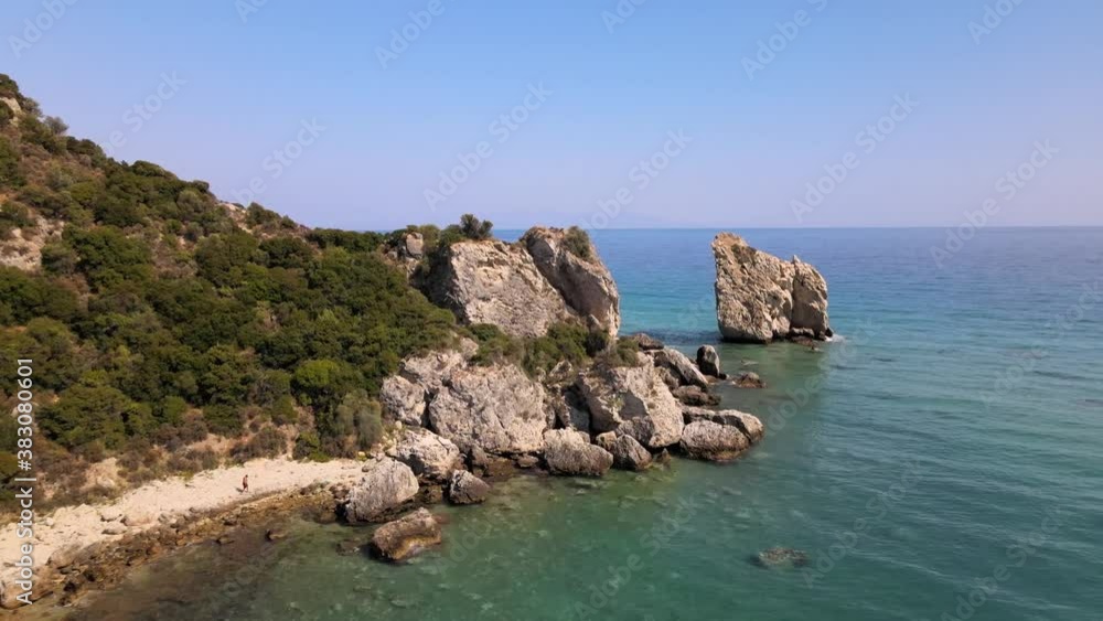 Aerial drone clip moving over a sandy beach towards a rock formation in Kavala, Macedonia, Greece Aerial drone clip moving over a sandy beach towards a rock formation in Kavala, Macedonia, Greece