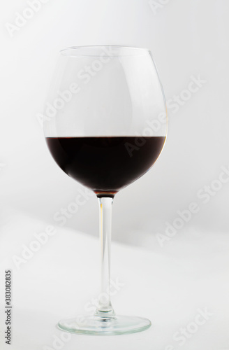A glass of red wine on a white background.