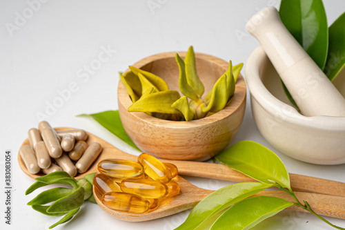 Photography Alternative medicine herbal organic capsule with vitamin E omega 3 fish oil, mineral, drug with herbs leaf natural supplements for healthy good life
