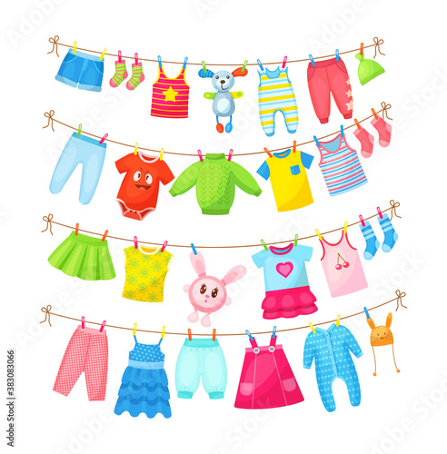 Baby clothes hanging on clothesline. Drying children's clothes and accessories after washing on rope. Shorts, socks, romper, sweater, hat, toys, T-shirt, sarafans, dress, skirts, blouse cartoon