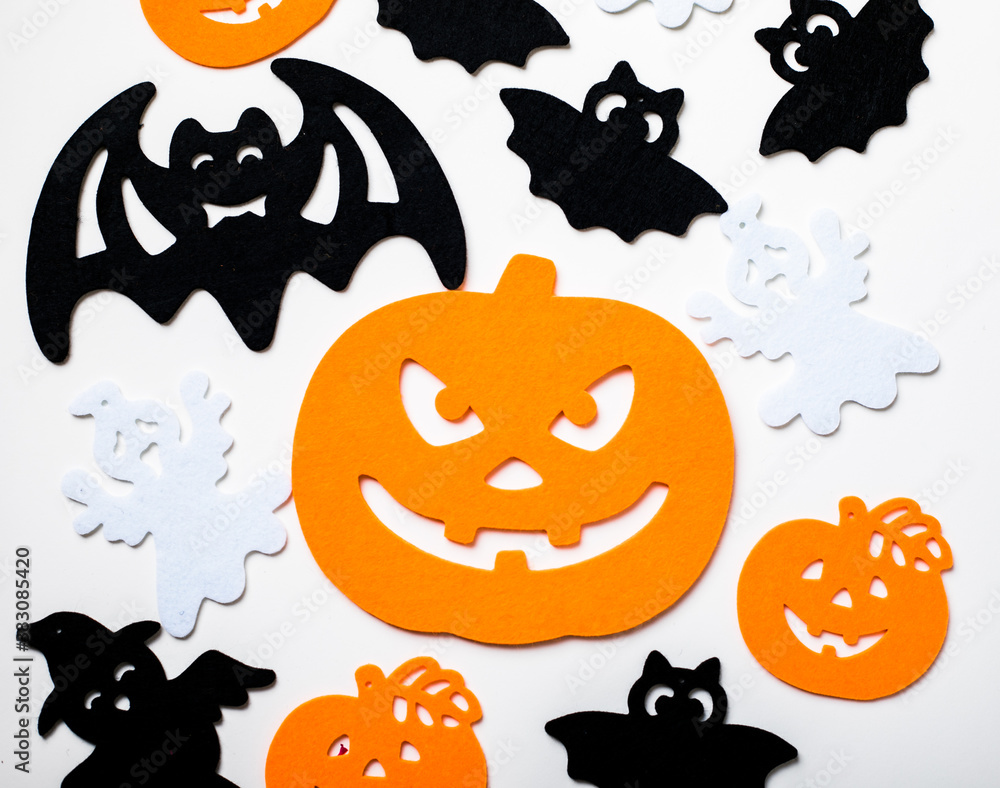 Frame of halloween decoration on pastel white background. Flat lay orange pumpkins, spooky spiders, bat, insects. Top view with copy space. Holiday greeting card mockup. Frame of halloween decoration on pastel white background. Flat lay orange pumpkins, spooky spiders, bat, insects. Top view with copy space. Holiday greeting card mockup.
