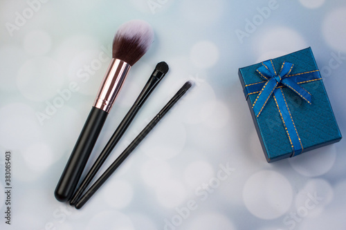 Different size makeup brushes. Round eye shadow palettes for women