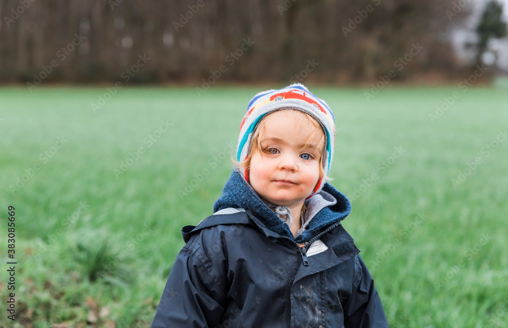 Happy toddler girl in front of field Happy toddler girl in front of field