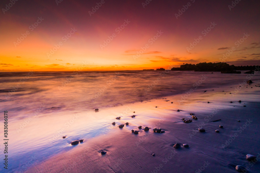 Beautiful Mengening Beach Sunset in Canggu Bali and Golden Hours at Sky with Black Sand Reflection Color
