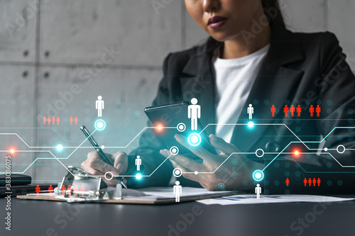 Businesswoman taking notes and social media icons hologram. Double exposure. Technology security network solution concept.