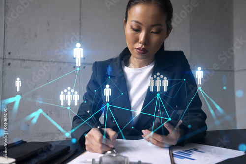 Businesswoman taking notes and social media icons hologram. Double exposure. Technology security network solution concept.