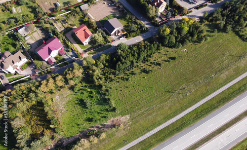 Top view of suburban villas near the park. Landscape with roofs of small houses