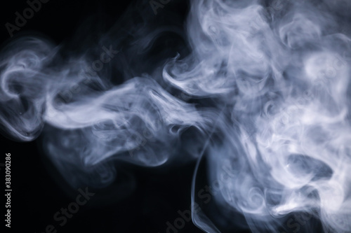 White cigarette smoke texture in a black background.
