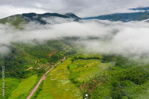 Fotografija Aerial view over valley surrounded by mountains and covered with dense ground fog and mist High peaks wonderful morning sunrise natural Landscape