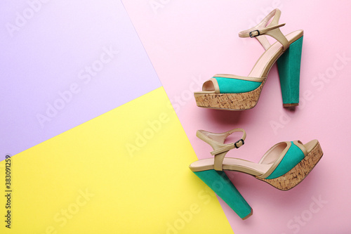Green high heel shoes on colorful background