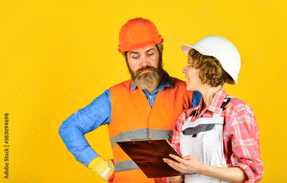 engineers couple working together on building blueprint. work at construction site or factory. Civil engineering. industrial business partner. job and occupation. confident electrical and technician engineers couple working together on building blueprint. work at construction site or factory. Civil engineering. industrial business partner. job and occupation. confident electrical and technician