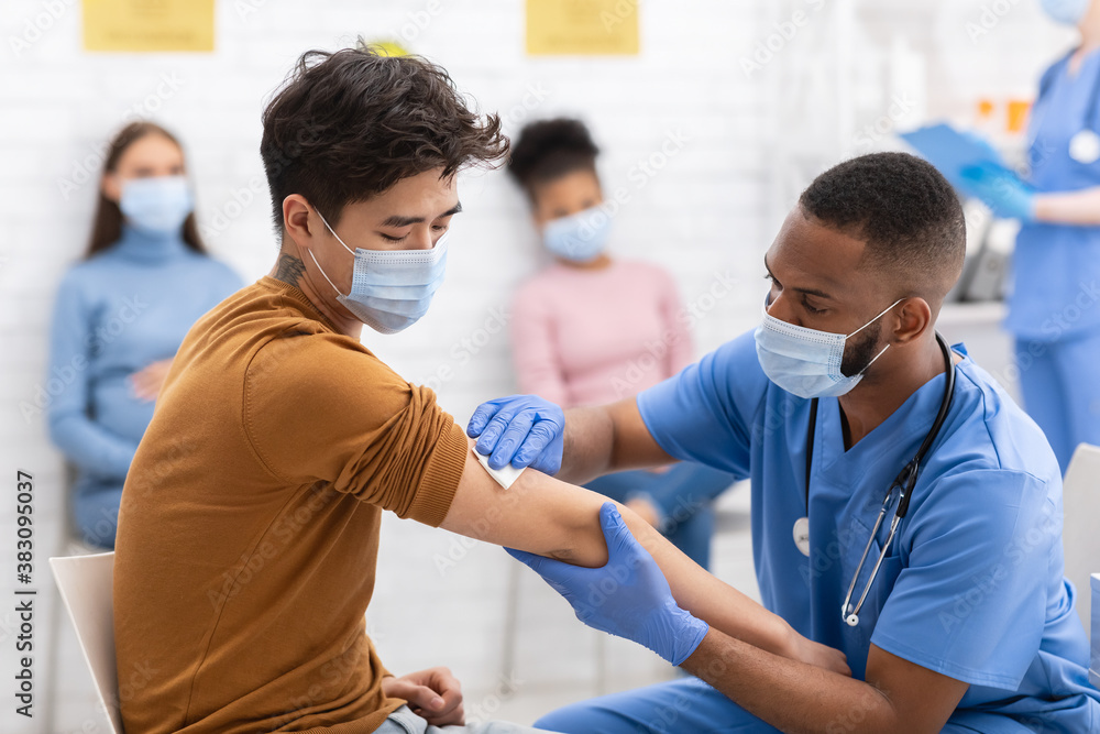 Fototapeta premium Asian Man Receiving Coronavirus Vaccine Injection During Appointment In Hospital