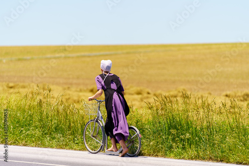 Obraz na plátně Bare feet Amish Girl Uses Bicycle Scooter