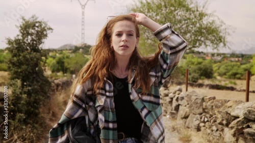 Travelling of a good-looking model looking to the camera while taking off her sunglasses