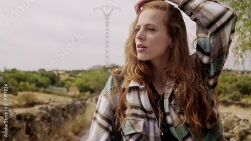 Travelling of a pretty girl adjusting her ginger hair