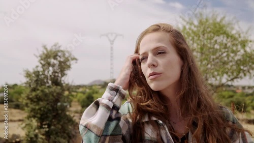 Travelling of a beautiful woman walking to the camera, puts on her sunglasses