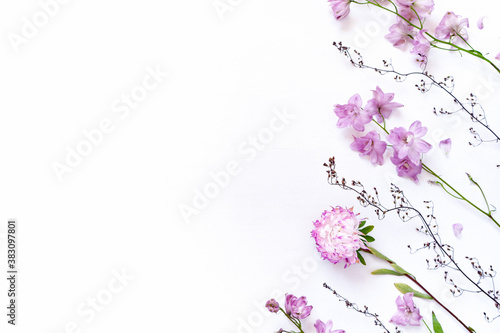 Autumn flower arrangement. Aster and delphinium flowers are on a white chipped background. Flat lay. Top view. Copy space. © happy_e