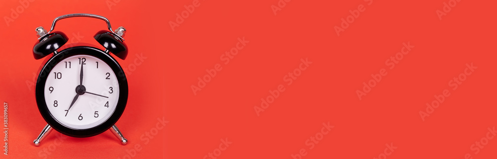 Classic analog clock with bells. Isolated on red background, copy space template, banner. Classic analog clock with bells. Isolated on red background, copy space template, banner.